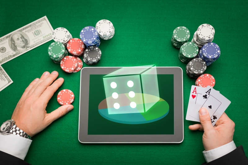 10749749-casino-poker-player-with-cards-tablet-and-chips